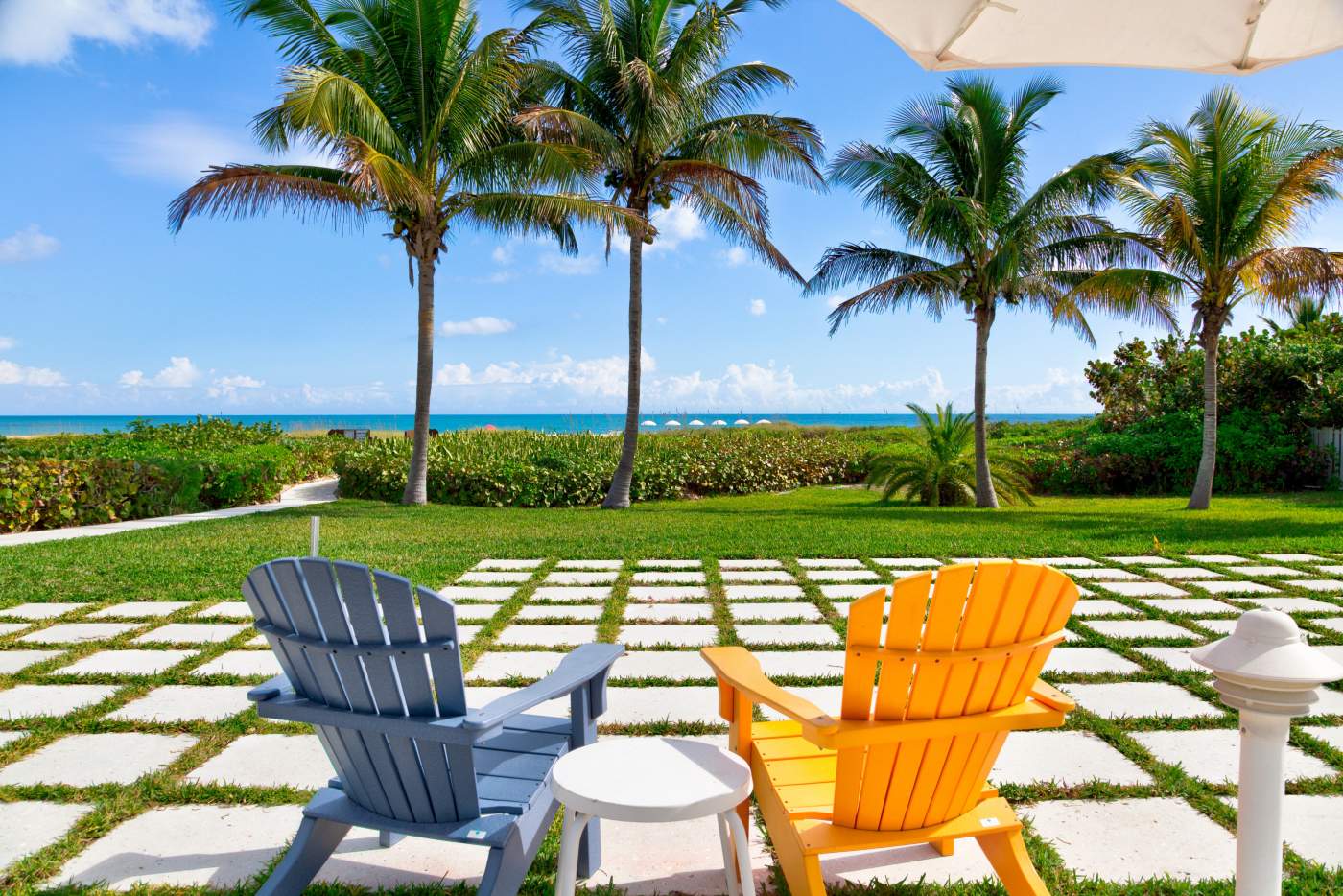Blue and orange chairs outside with beach in the background