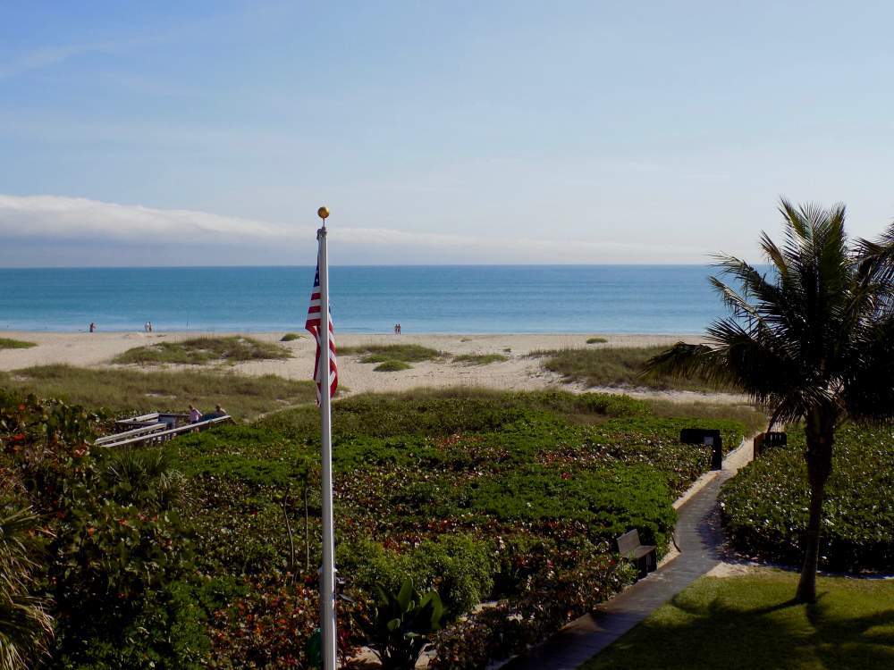 American flag with the beach in the background